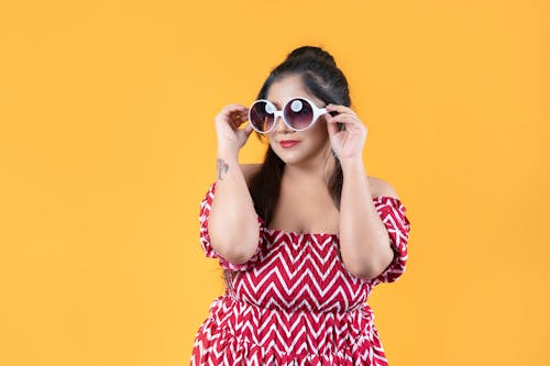 A Woman in a Dress Wearing Sunglasses 