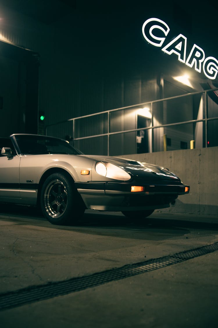 Retro Car With Lights On Night Street