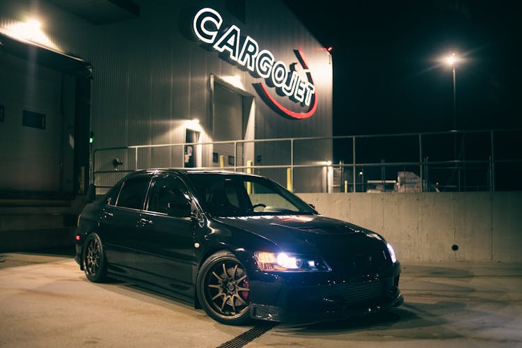 Car Parked In Front Of Warehouse Entrance