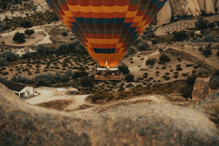 People On The Basket Of An Airborne Hot Air Balloon