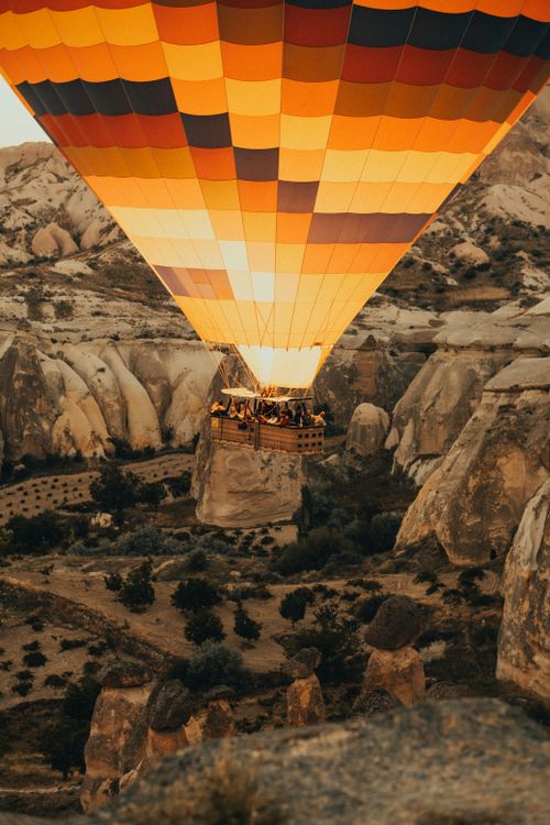 Free Stunning hot air balloon ride over Cappadocia's unique rock formations at sunset. Stock Photo