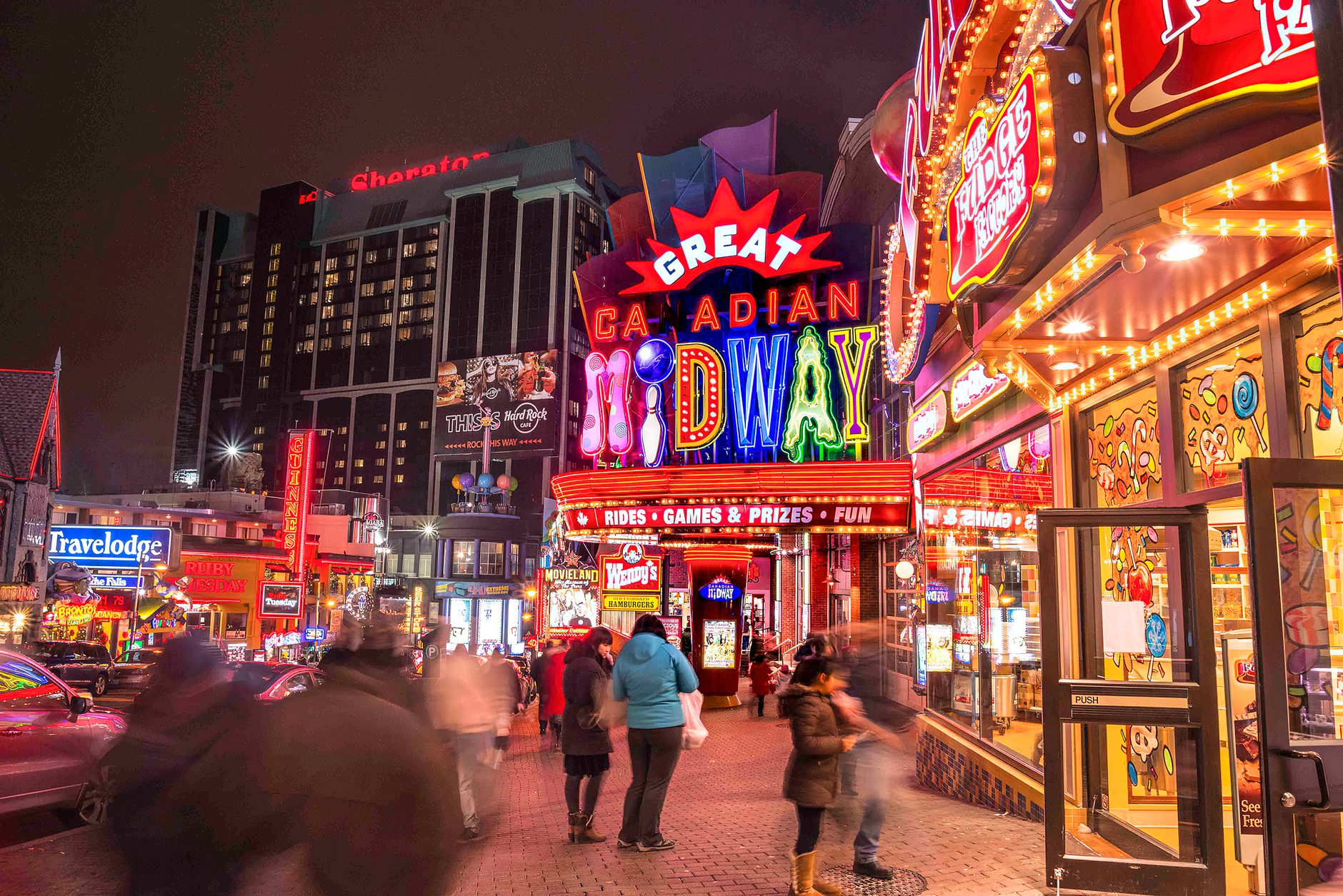 Experience the bustling and colorful night scene at the Great Canadian Midway in Niagara Falls, Ontario.
