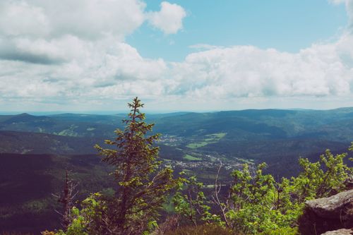 Free Breathtaking aerial view of mountains and forests under a cloud-filled sky. Stock Photo