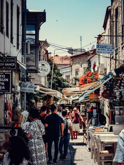 Free Vibrant street market scene showcasing people shopping amidst charming old buildings. Stock Photo