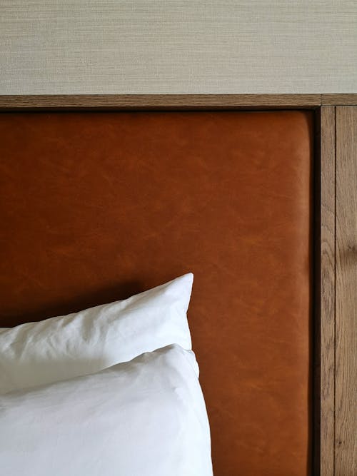 White Pillow on Brown Wooden Bed Frame