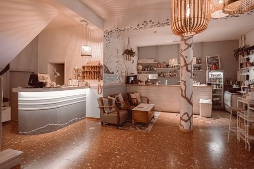 Free Stylishly decorated café interior featuring artistic elements and warm lighting, ideal for relaxation. Stock Photo