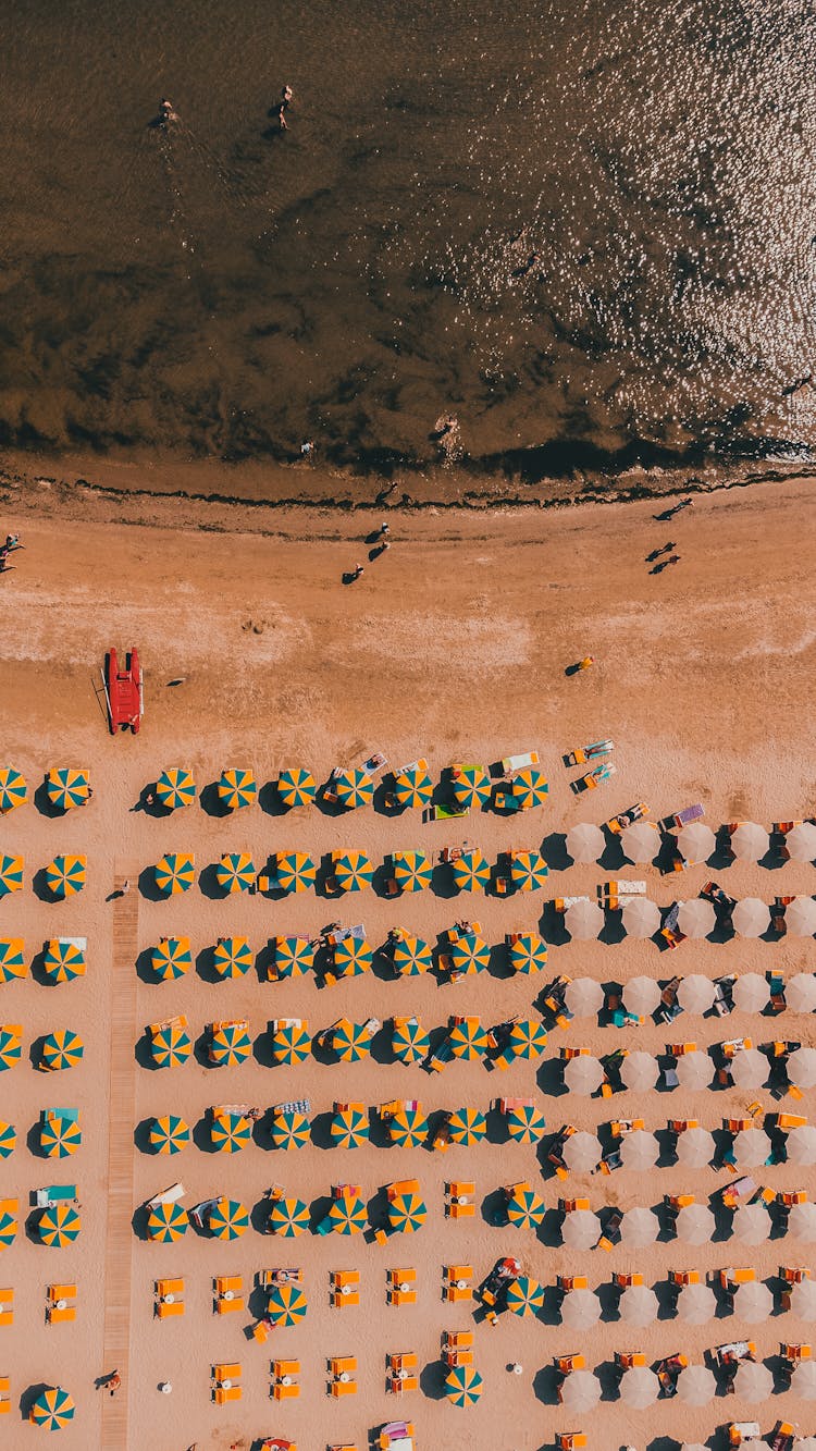 Colorful Umbrellas On Beach Near Sea