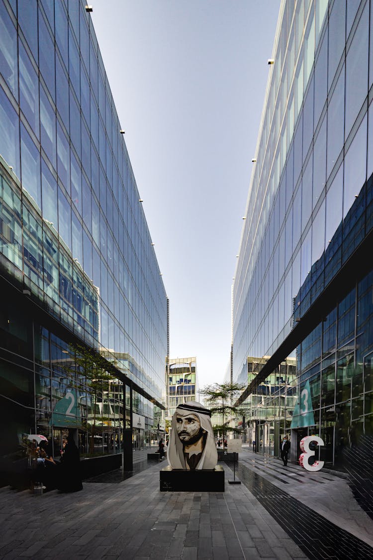 Sculpture In Between Glass Buildings