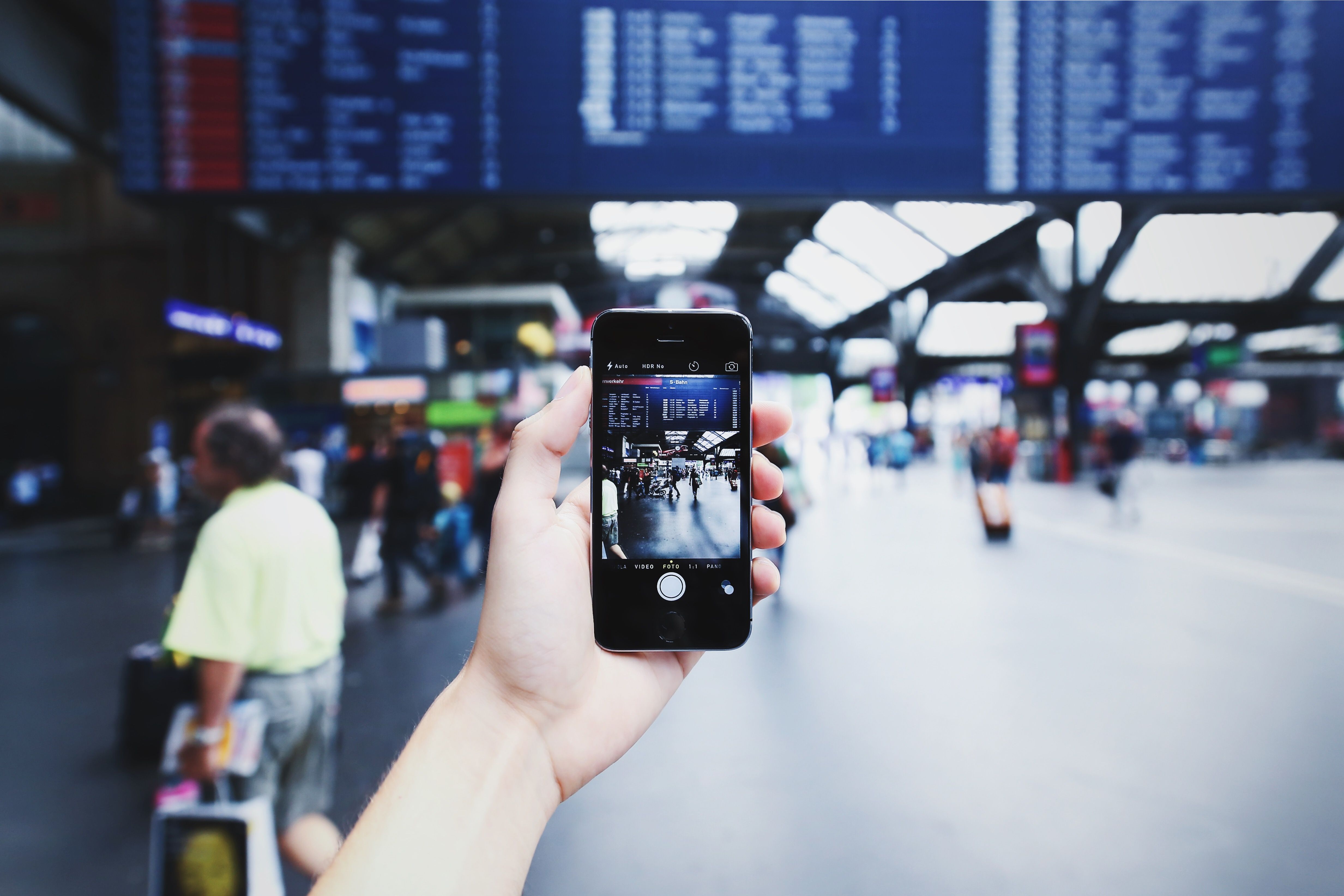 Checking a smartphone at a busy Japanese train station