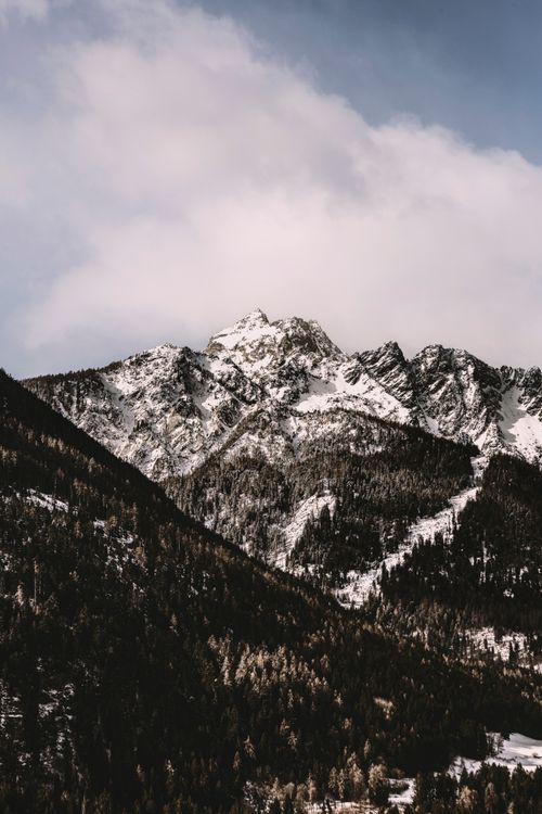 Free Majestic snow-capped peaks of the Swiss Alps during winter, captured in Rossura, Switzerland. Stock Photo