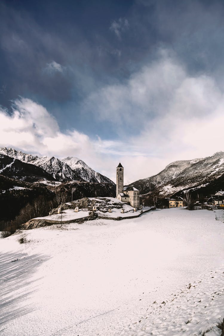 Tower In Snow Covered Mountain Valley