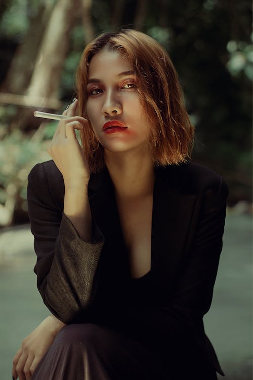 Woman with Short Hair Holding a Cigarette