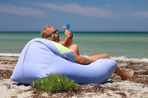 Man Lying Down on a Pillow in the Beach