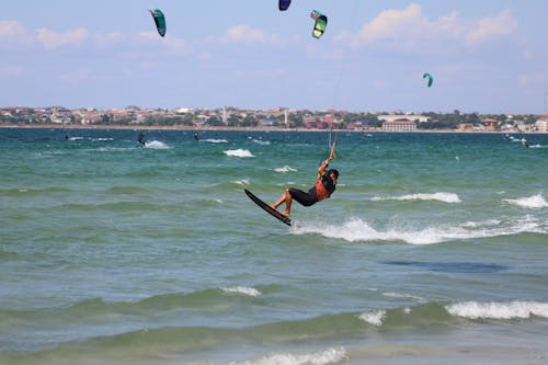 Free People in Sportswear Kitesurfing on Sea Stock Photo