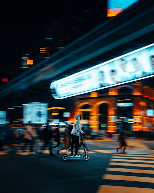 Free Man in White Jacket Riding Bicycle on Road during Night Time Stock Photo