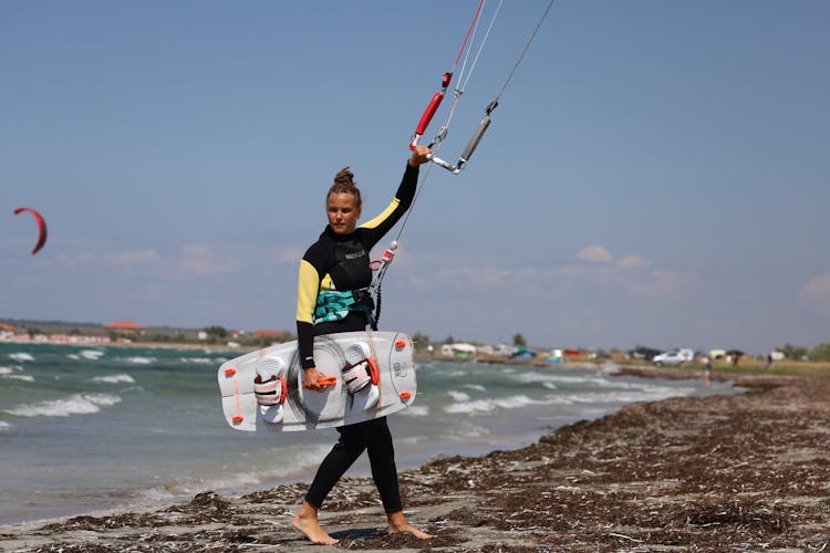 A Woman Holding A Wakeboard