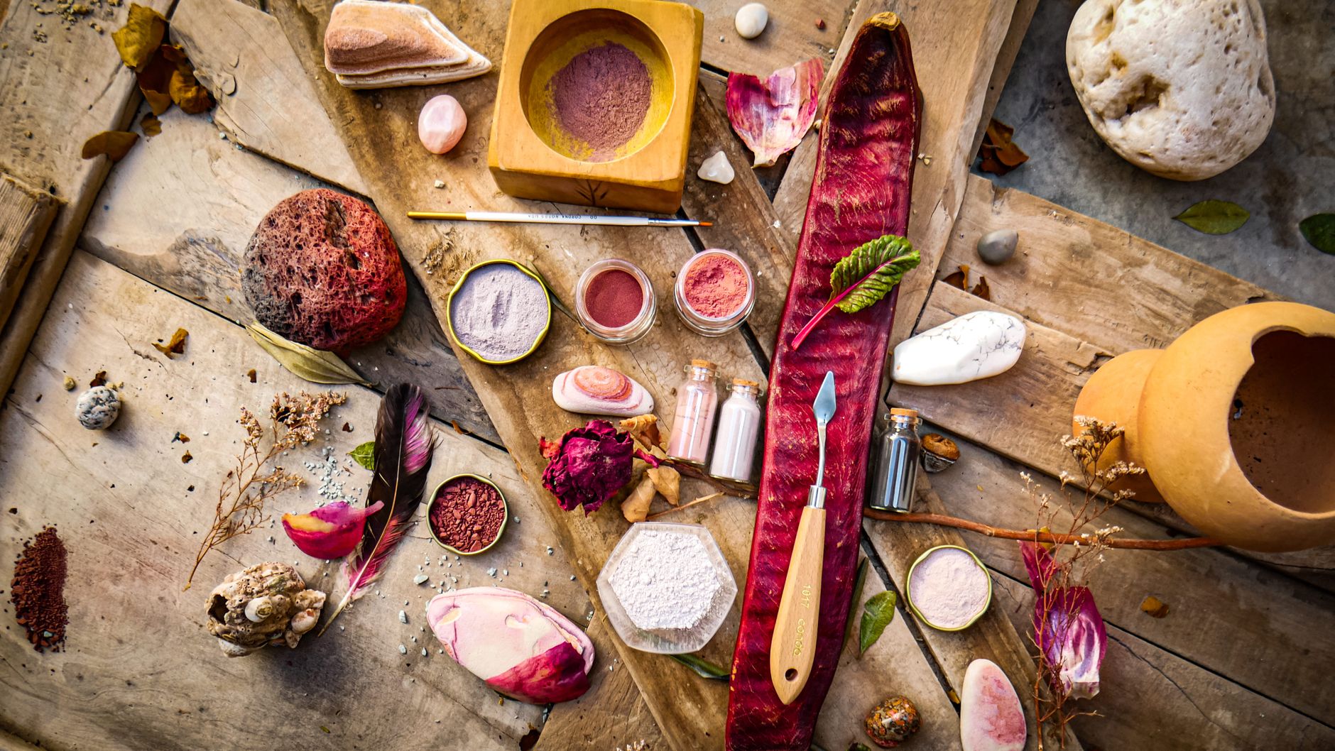 zeolite detox protocol — A creative flat lay with natural pigments, tools, and artistic elements on a wooden surface.