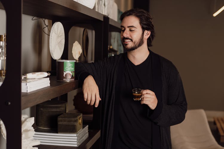 A Man Holding A Coffee Drink