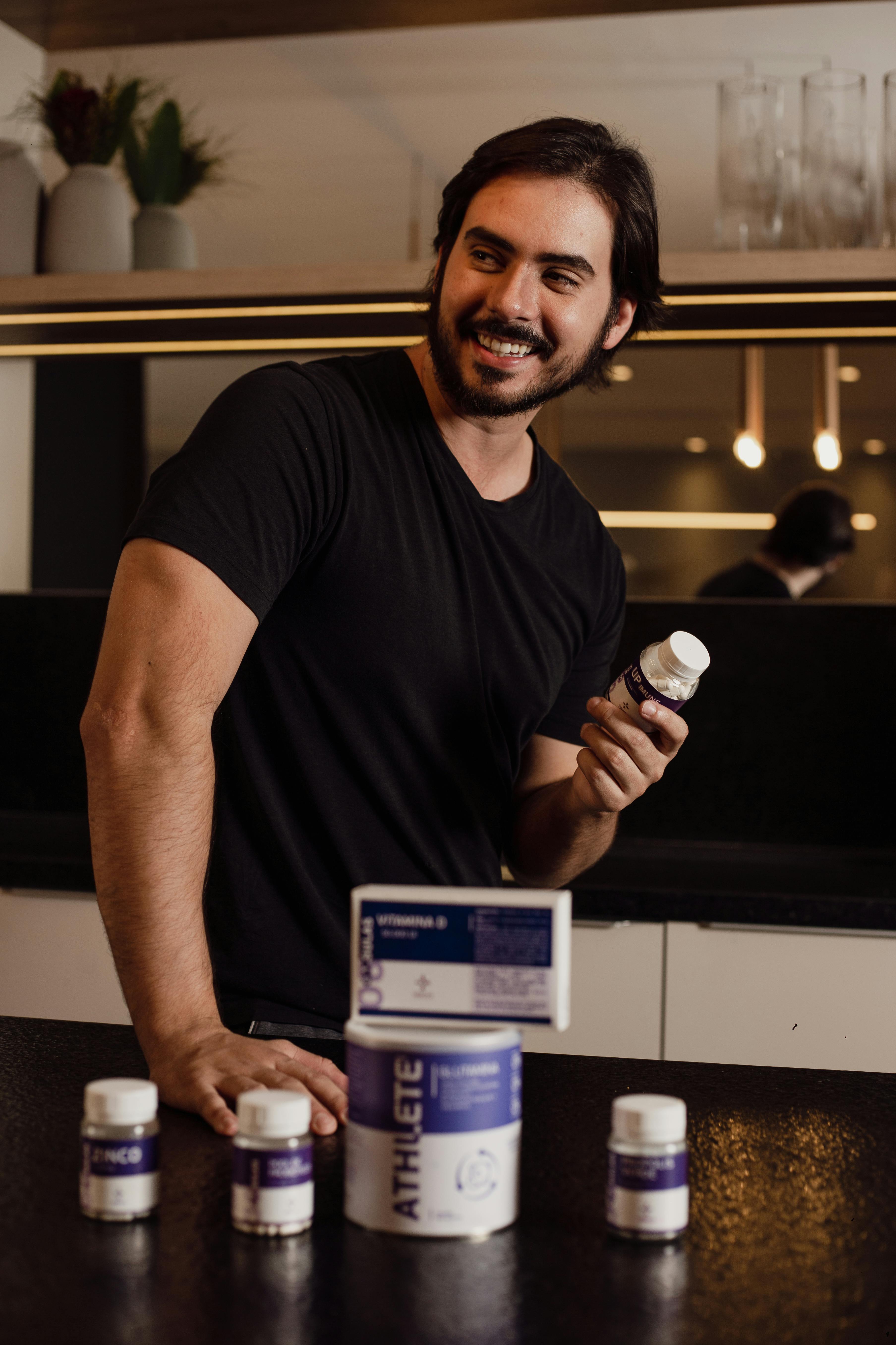 a man with supplements in a kitchen