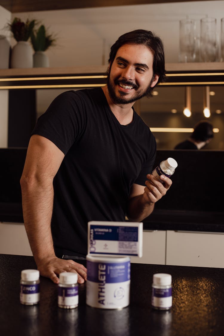 A Man With Supplements In A Kitchen