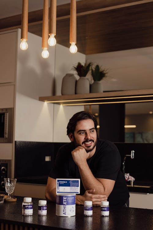 A Man Sitting at the Table with Medicines