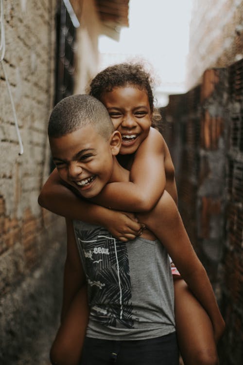 Free Brother Carrying Sister Piggyback Stock Photo