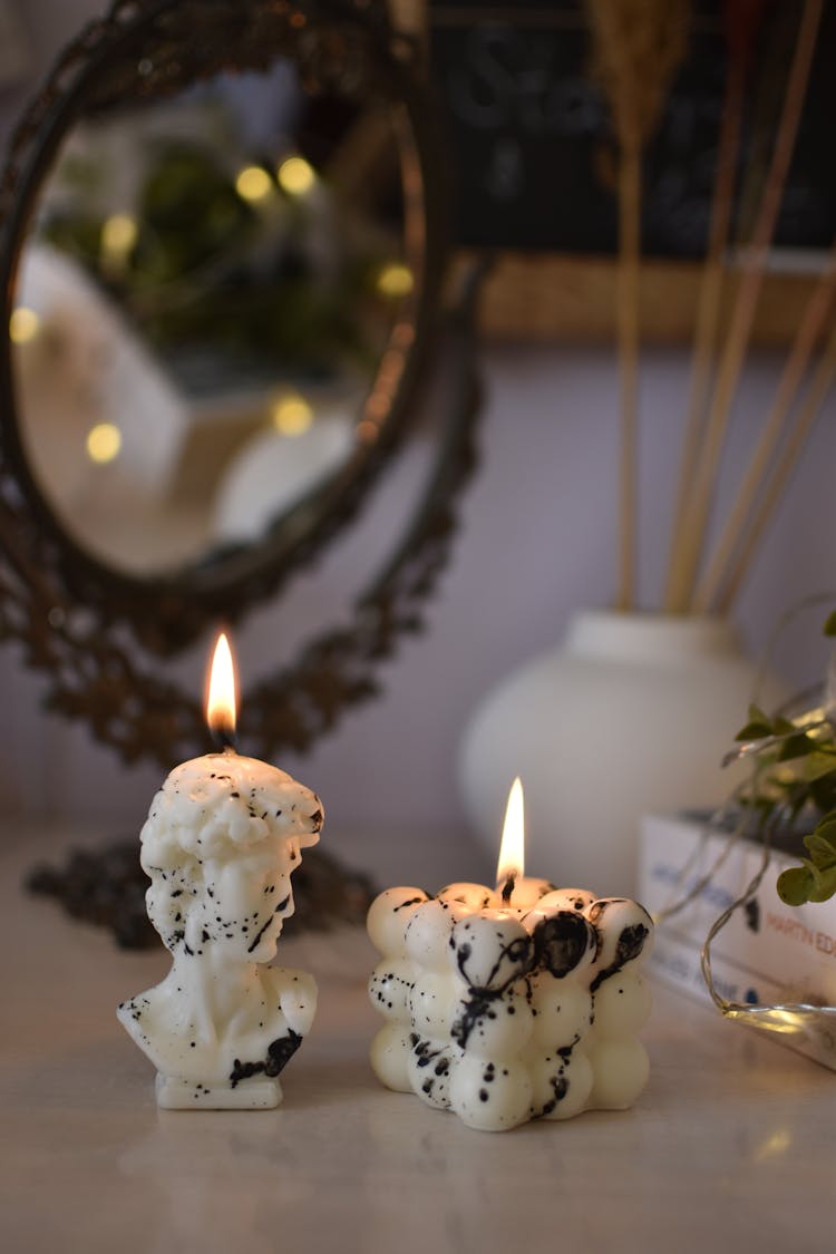 Close-Up Shot Of Lit Candles 