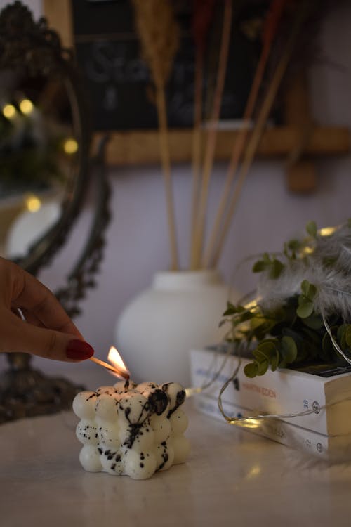 A Person Lighting a Candle 