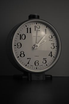 Monochrome close-up of a vintage desk clock showing 9:35.