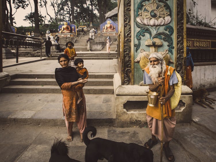 People In Traditional Clothes Near Old Temple