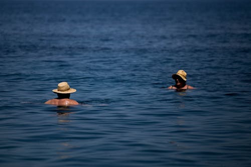 A Man and Woman Swimming in the Sea