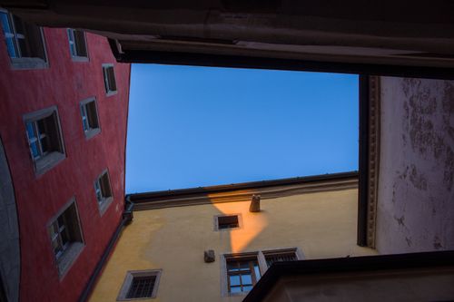 Free Low angle view of vibrant buildings against a blue sky in Regensburg, Germany. Stock Photo