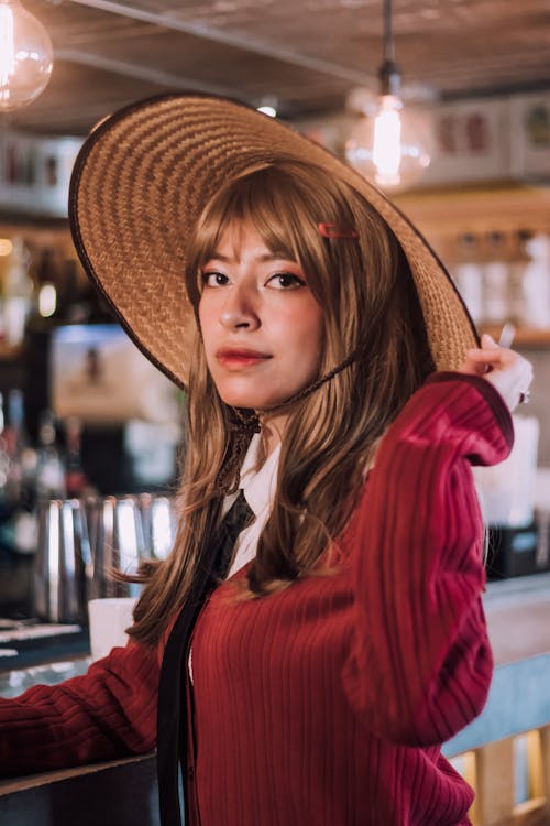 A Woman in Red Jacket Wearing Brown Hat