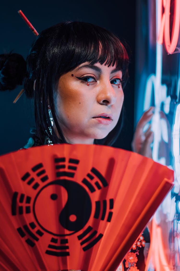 Woman Posing With Yin I Yang Fan