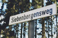 White and Black Siebenbergensweg Wooden Signage