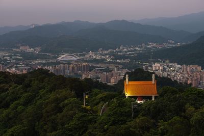 Temple roof among wooded hills above Taipei at twilight — photo by Max Chen on Pexels