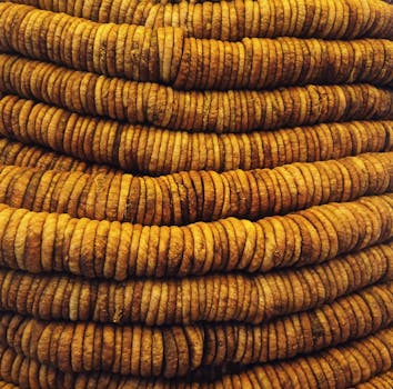 A stacked close-up view of rustic dried figs showcasing texture and pattern.