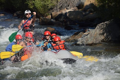 People Riding on Inflatable Raft