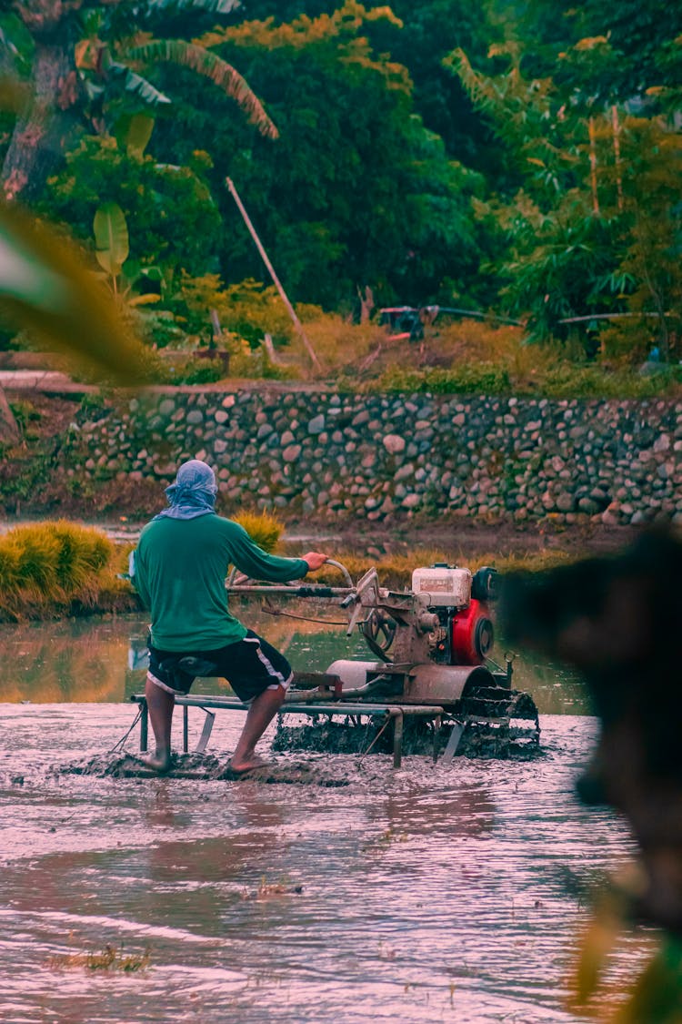 Person Working With Machine In Mud