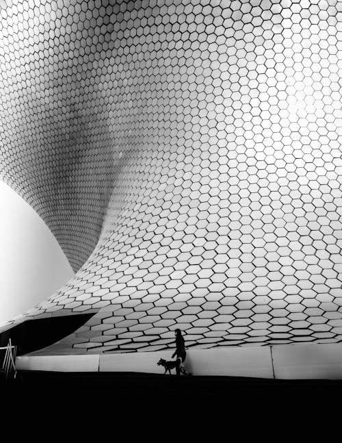 Person Walking near Modern Futuristic Building