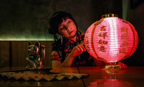 Free Photo of a Woman Touching a Red Lantern Stock Photo