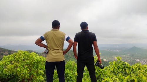 Free Two friends enjoying scenery view from mountain Stock Photo
