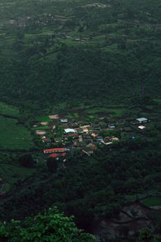 Capture of a secluded village nestled in lush green countryside, ideal for countryside themes.