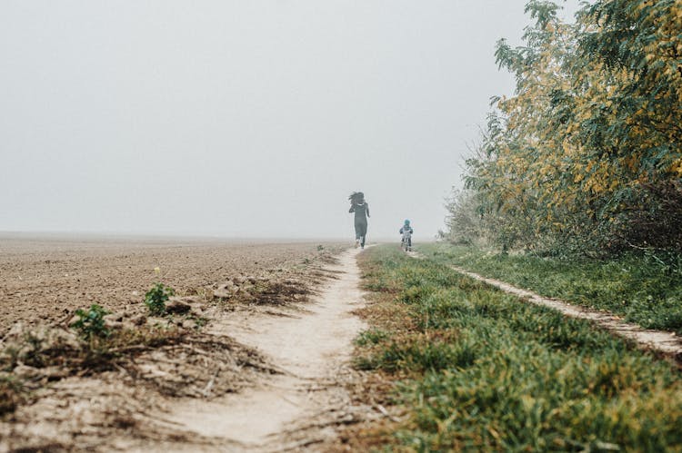 A Woman Running On Dirt Road