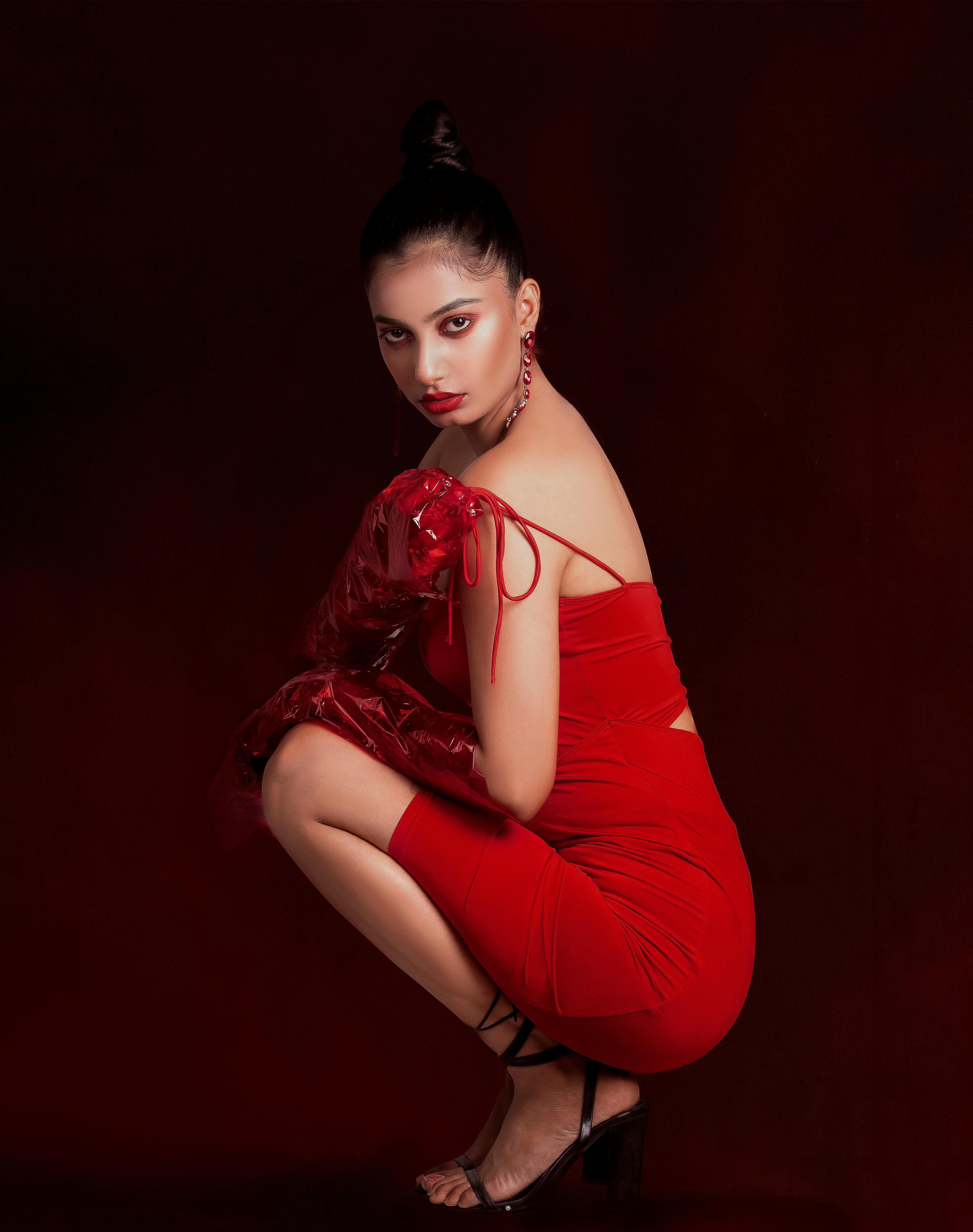 Woman In Red Dress Posing Fiercely On The Camera · Free Stock Photo