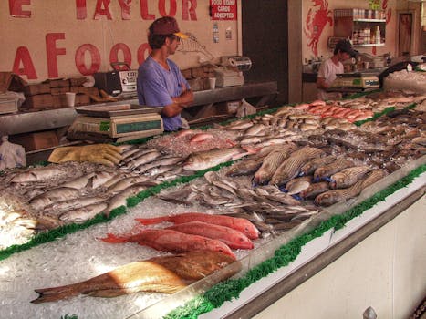 A busy seafood market stall showcasing fresh fish and a vendor in Washington, DC, United States.