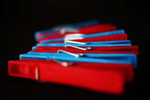 Free Selective Focus Photography of Red and Blue Clothes Pins Stock Photo