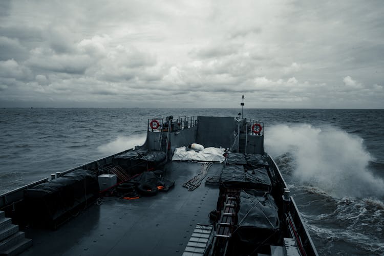 Black Ship On Sea Under White Clouds