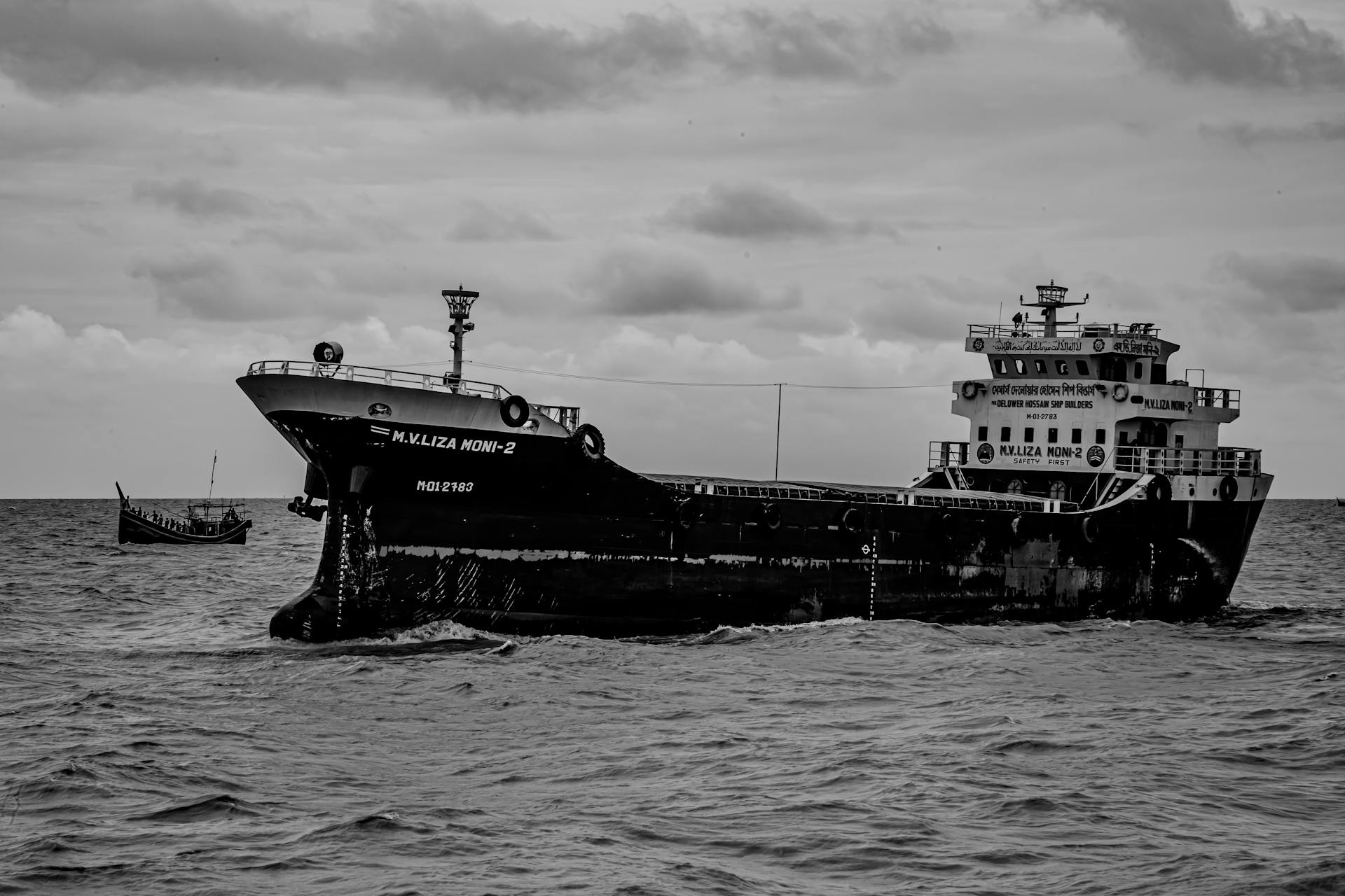 Grayscale Photo of Ship on Sea