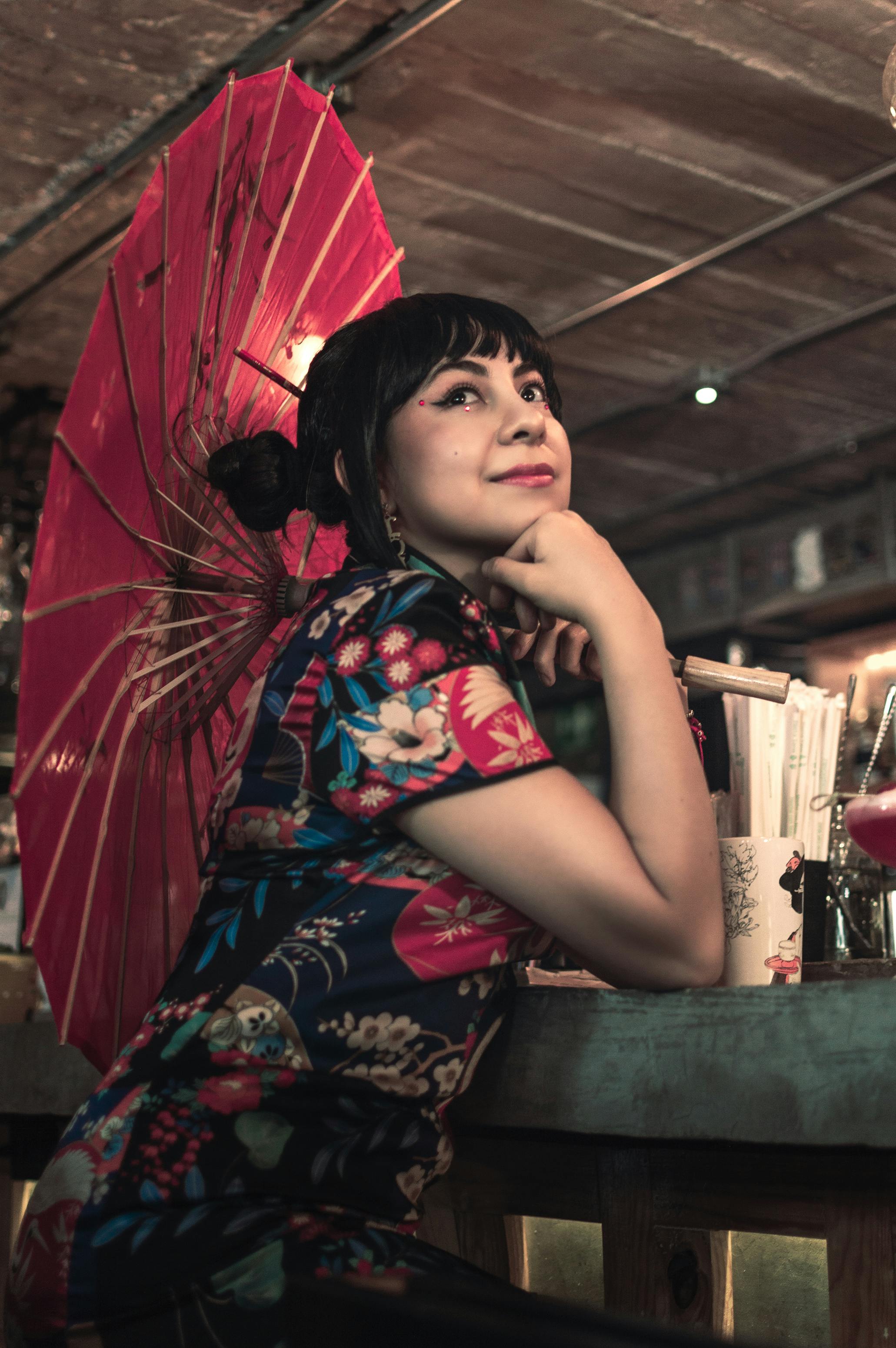 Pretty japanese woman with umbrella posing isolated on pink Stock Photo by  LightFieldStudios